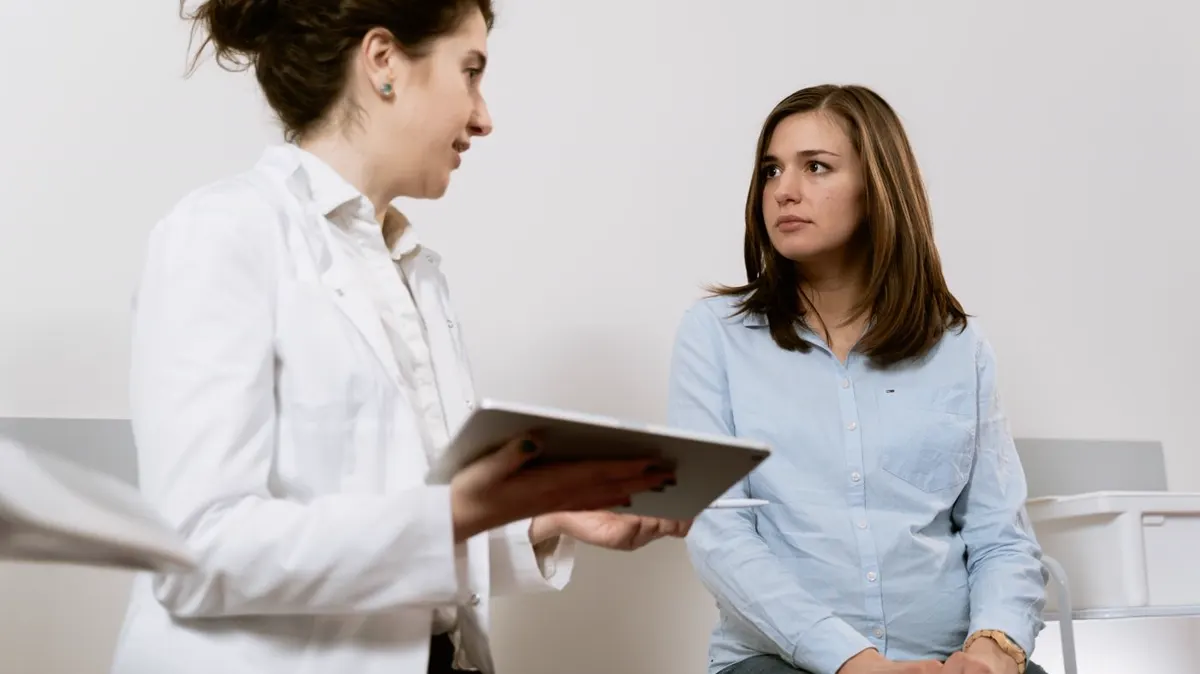 Two women discussing health information during a consultation