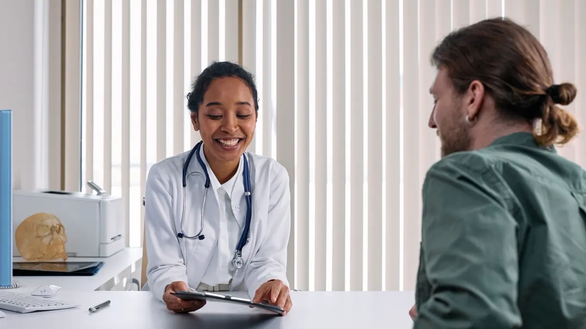 A patient speaking with a healthcare professional in a clinic